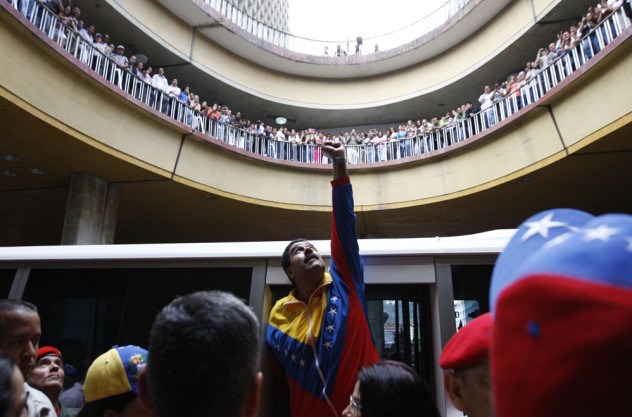 Venezuela's acting President Maduro gestures to supporters after he registered as a candidate for president in the April 14 election outside the national election board in Caracas