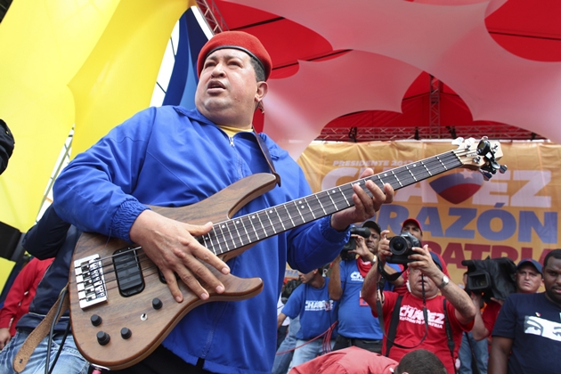 Venezuela's President Chavez plays guitar during an election rally in Valencia