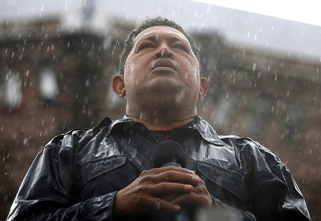 Venezuela's President and presidential candidate Hugo Chavez speaks in the rain during his closing campaign rally in Caracas
