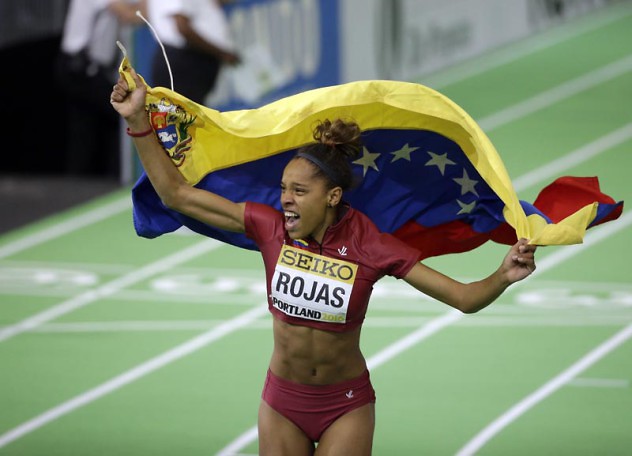 Venezuela's Yulimar Rojas celebrates with a flag after she won the women's triple jump final during the World Indoor Athletics Championships, Saturday, March 19, 2016, in Portland, Ore. (AP Photo/Rick Bowmer)